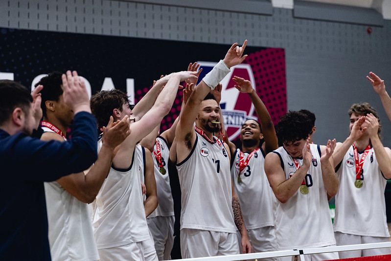 Newcastle University basketball team celebrating with medals